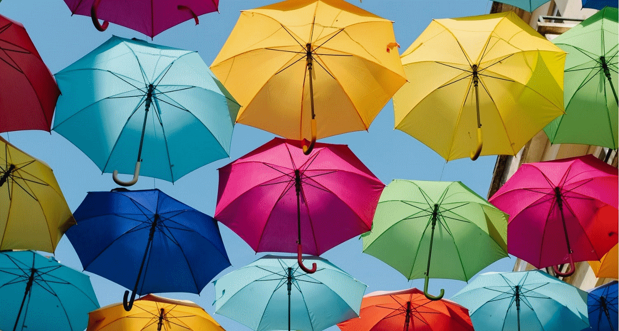 Colourful umbrellas against a blue sky