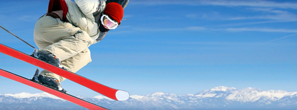 Skier jumping in front of mountains