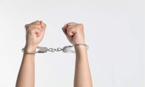 Person's hands in handcuffs