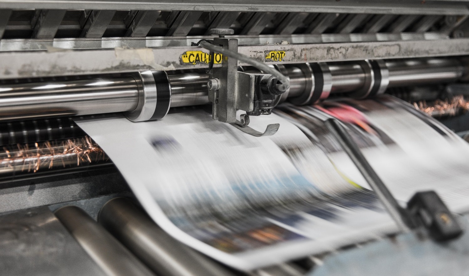 Printing press printing out a newspaper