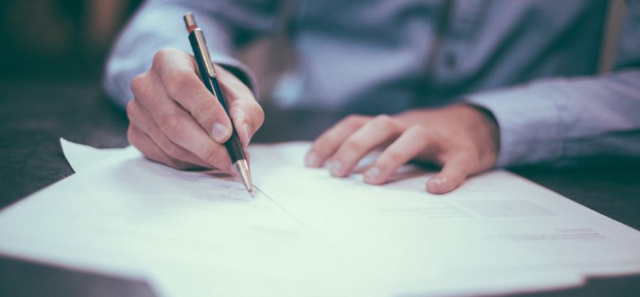 Pen signing documents.