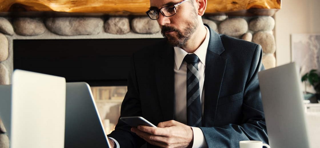 Businessman working at a wooden desk.