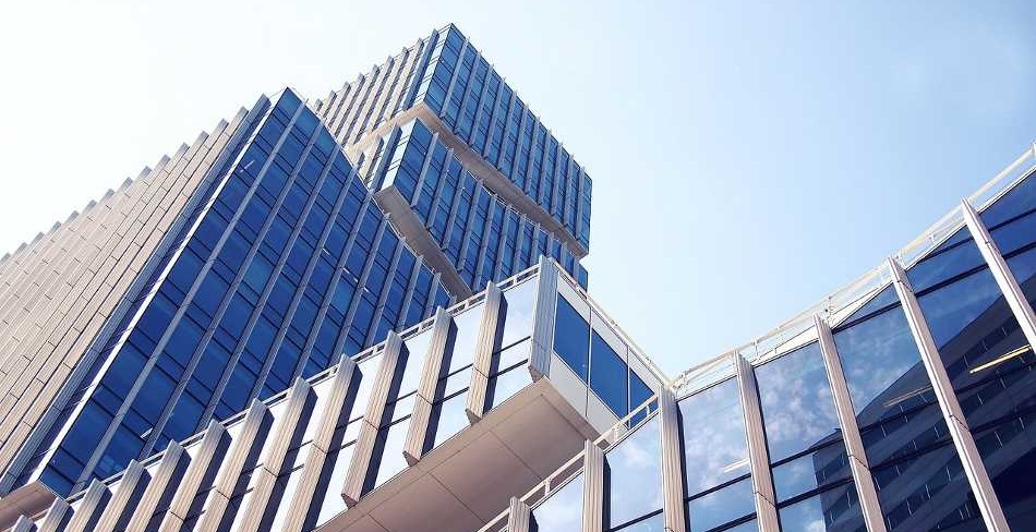 Modern commercial buildings against a blue sky