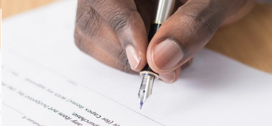 Person signing a legal document