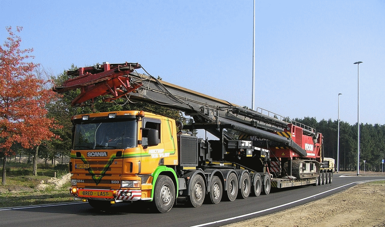 Orange SCANIA truck against a blue sky