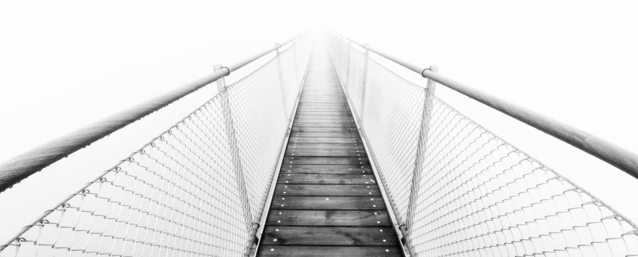 A swingbridge disappearing in fog.