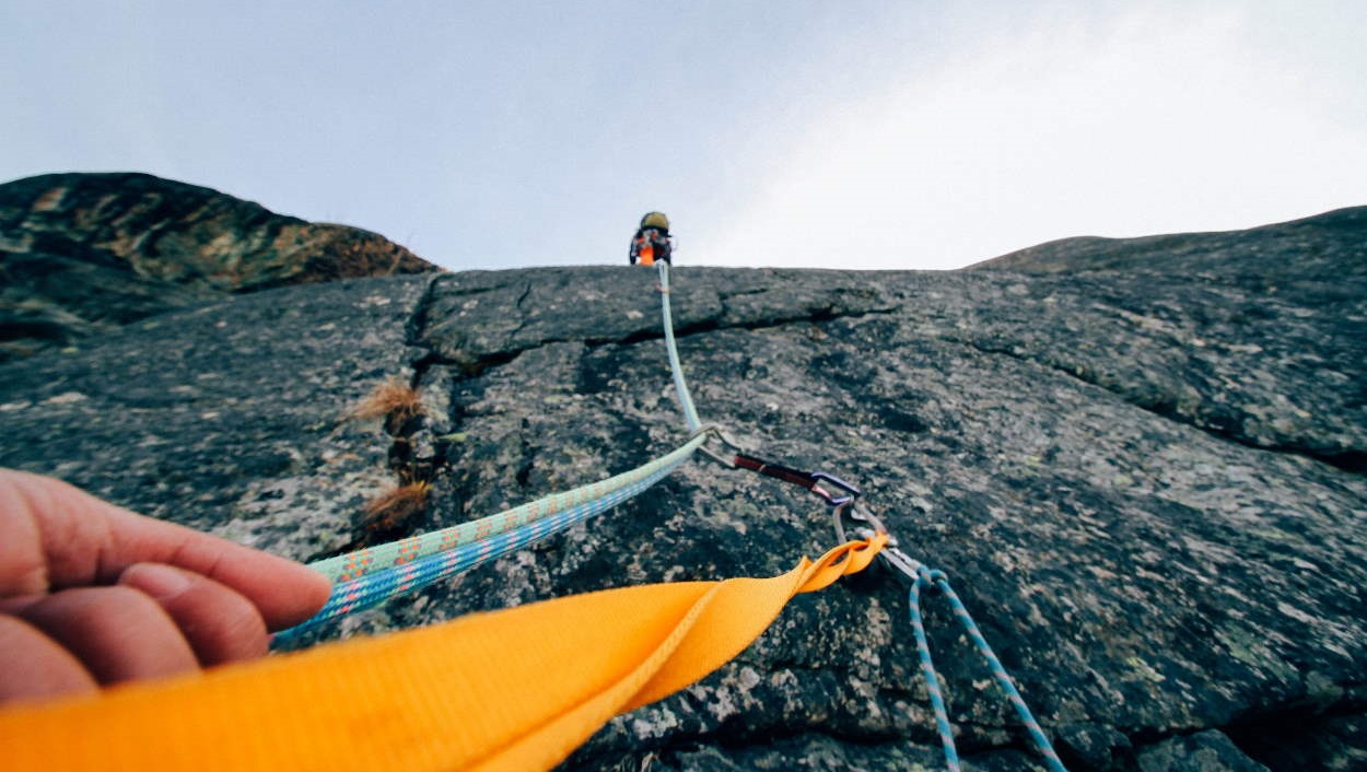 Two climbers conquering a mountain.