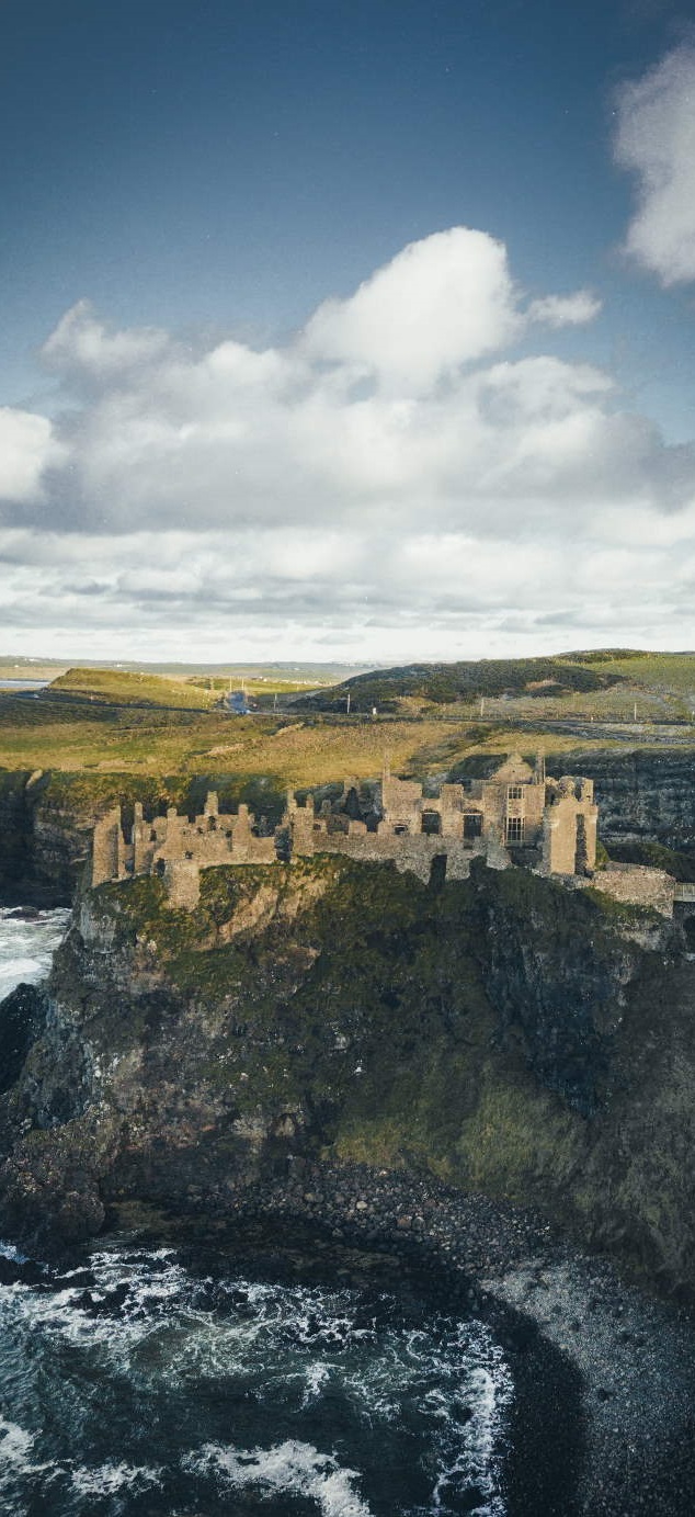 Photo of the Irish coastline, with an old castle.