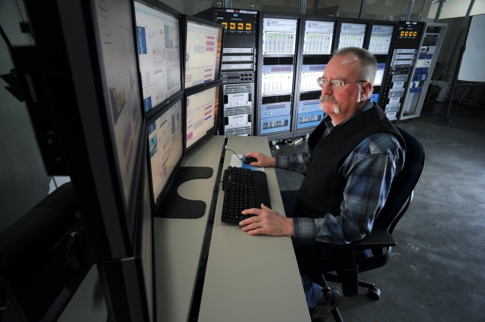 Power grid operator looking at screens.