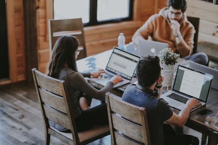 Professionally dressed people working at a large table