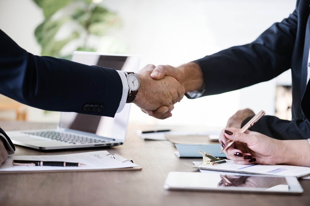 Business people shaking hands over a desk