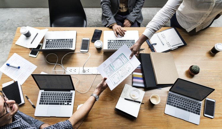 People working together at a big shared desk