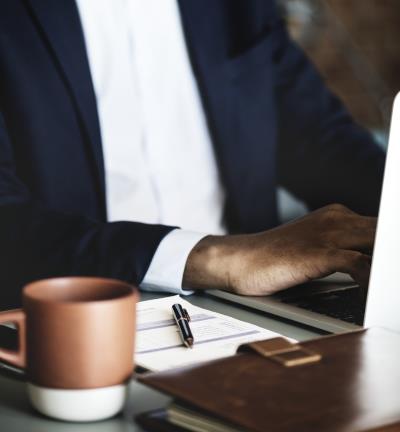 Man in a suit sitting at his computer