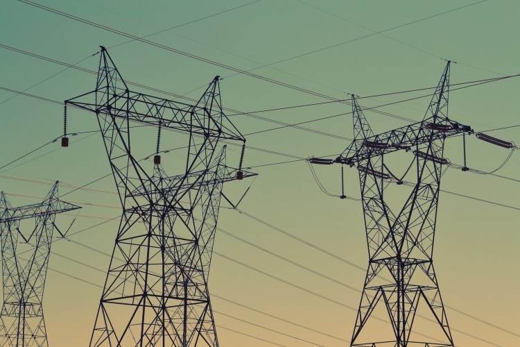 Power towers against a setting sun