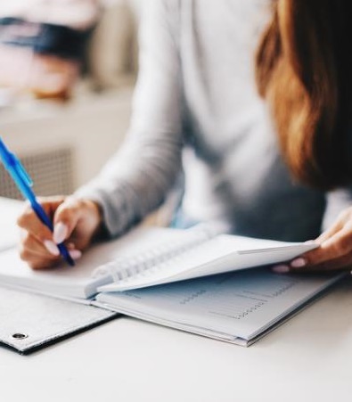 Woman writing in a planner