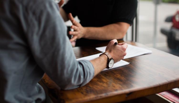 Men working together on documents