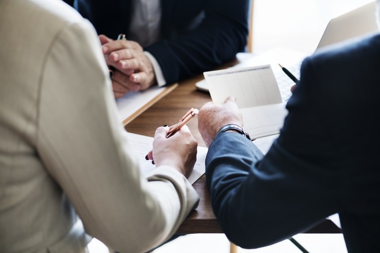 People in suits working at a conference table