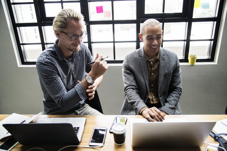 Two men sitting at their computers