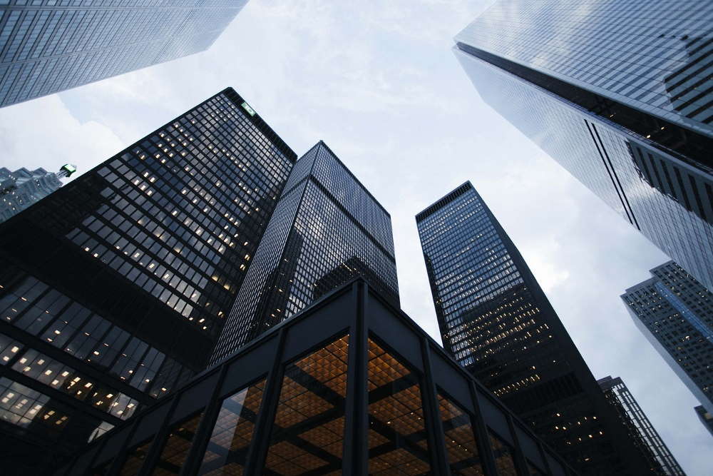 Low angle photo of high scyscrapers and the sky against them.